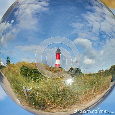 Crystal ball reflecting a lighthouse behind it Stock Photo
