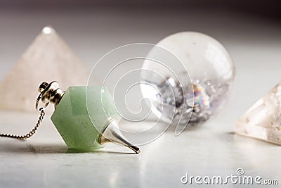 Crystal ball, rock crystal pyramid and Pendulum Stock Photo