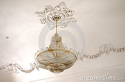 Crystal chandelier in gilded frame with rosette ceiling Editorial Stock Photo