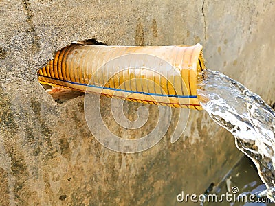 Crystal clear sweet and healthy water being flush out by a petrol engine tube well in the wheat fields where the river water can` Stock Photo