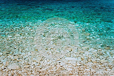 Crystal clear turquoise waters, peaceful bay with calm transparent water surface. Idyllic Summer vacation consept Stock Photo