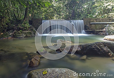 Crystal clear water with waterfall in the forest Stock Photo