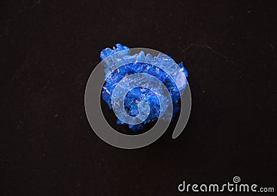 Crystal of Copper sulphate, Bright Blue Vitriol on Black Stock Photo
