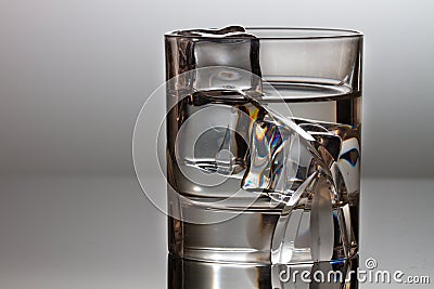 A crystal glass with water and cubes of clown Stock Photo