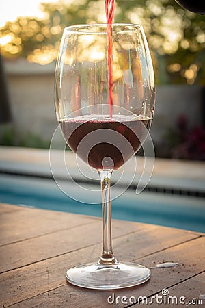 Crystal goblet with red wine. Alcoholic drink based on fermented grape juice. High social class drink concept Stock Photo