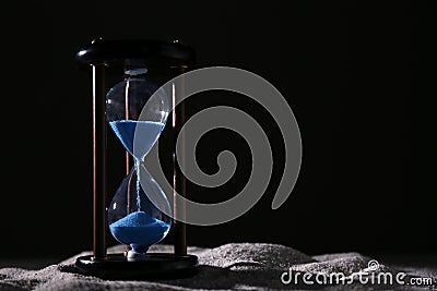 Crystal hourglass on dark background. Time management concept Stock Photo