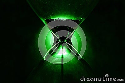 Crystal Hourglass on green background, inspirational time pass concept Stock Photo