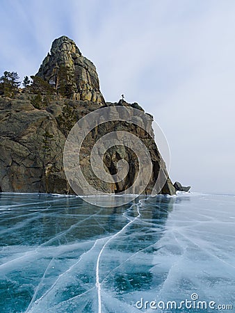 Crystal ice of lake Baikal and a rock Stock Photo