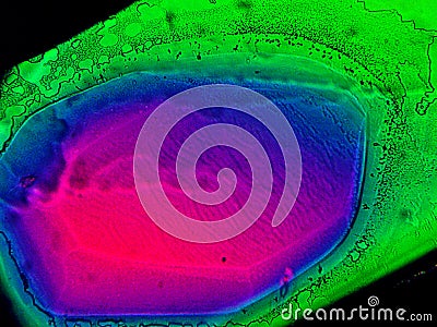 Crystal layer on microscope object glass, seen in polarized light. This causes random unforeseeable color effects Stock Photo