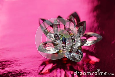 Crystal lotus on red table with light reflection. Muladhara chakra symbol Stock Photo