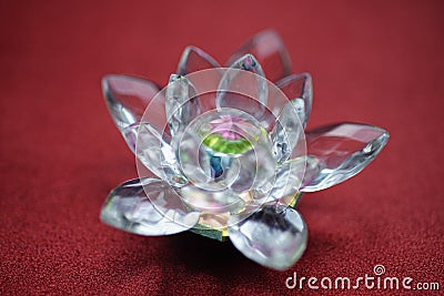 Crystal lotus on red table. Muladhara chakra symbol Stock Photo