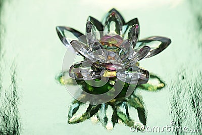 Crystal lotus on shiny green background with light reflection. Anahata chakra symbol Stock Photo