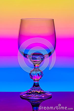Crystal wine glass on a background of colored gradient Stock Photo