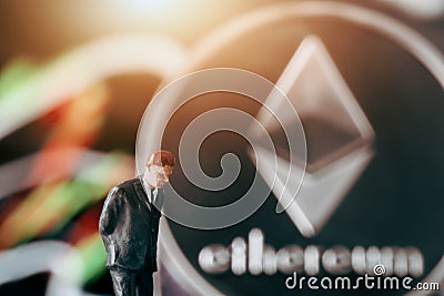 crytpocurrency concept with businessman in front of ethereum and stock market chart Editorial Stock Photo