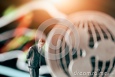 Crytpocurrency concept with businessman in front of ripple and stock market chart Editorial Stock Photo