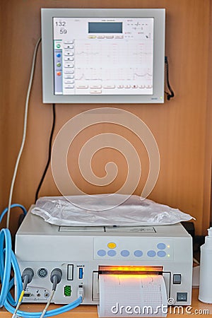 CTG device with monitoring of the state of health of the mother and child during childbirth in the hospital. Cardiotocograph Stock Photo