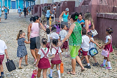 CUBA - APRIL 7, 2016: Schoolchildren with their parents going to school Editorial Stock Photo