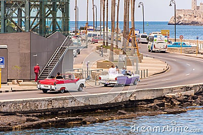 CUBA, HAVANA - MAY 5, 2017: American colorful retro cars traveling along the waterfront. ï¿½opy space for text. Editorial Stock Photo