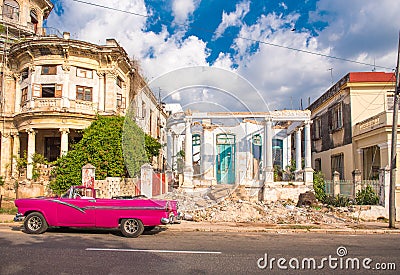 CUBA, HAVANA - MAY 5, 2017: American pink retro cabriolet on the background of buildings. Copy space for text. Editorial Stock Photo