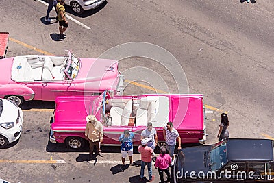 CUBA, HAVANA - MAY 5, 2017: American pink retro cars in the parking lot. Copy space for text. Top view. Editorial Stock Photo