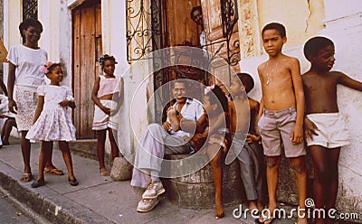 A cuban family sitting outside of the house on the street in La Habana vieja Editorial Stock Photo