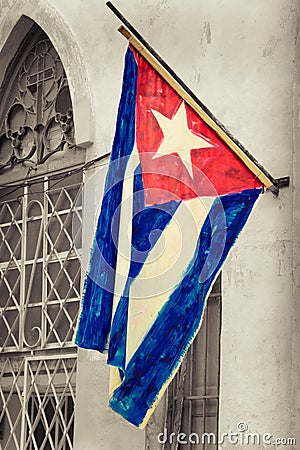 Cuban flag on a grunge decaying neighborhood Stock Photo