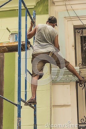 Cuban worker balancing on scaffold Havana Editorial Stock Photo