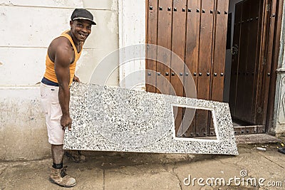 Cuban worker delivering kitchen zink of molded concrete Editorial Stock Photo