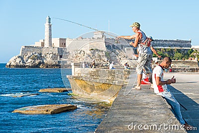 Cubans fishing in front of the famous El Morro castle in Havana Editorial Stock Photo