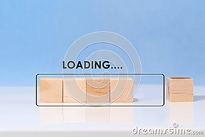 Cube block to completing progress bar with the word loading on blue background. Finish working or waiting Stock Photo