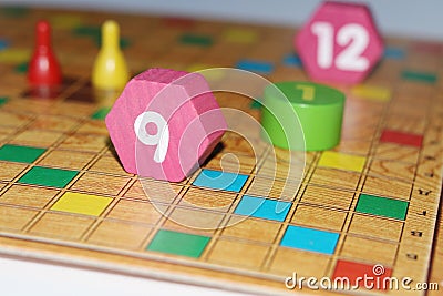 Cube, chips, wooden figures, a bright field for the game Stock Photo