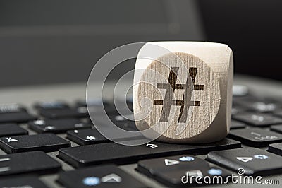 Cube Dice with Hashtag symbol on a keyboard Stock Photo