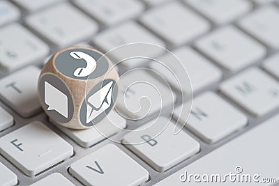 A cube with different contact options on a keyboard Stock Photo