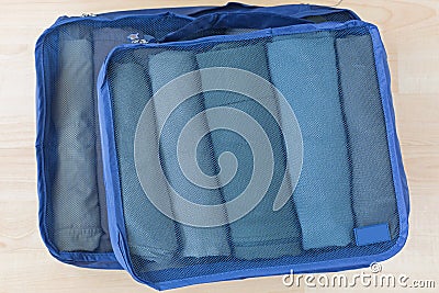 Cube meshed bags with rolled clothes. Set of travel organizer to help packing well organized Stock Photo