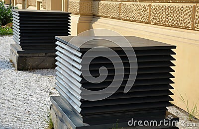 cube-shaped ventilation grid boxes. slats cover the air recovery ventilation pipe Stock Photo