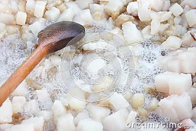 Cubed pork fat being rendered Stock Photo