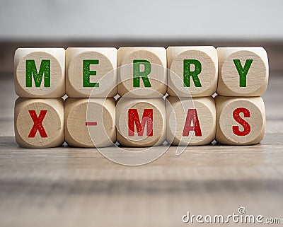 Cubes, blocks or dice with merry x-mas christmas on wooden background Stock Photo