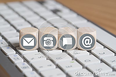 Cubes with contact options on computer keyboard Stock Photo