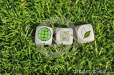Cubes, dice or blocks with climate change in green grass Stock Photo