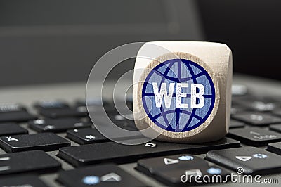 Cubes and dice with CMS and SEO on a laptop keyboard Stock Photo