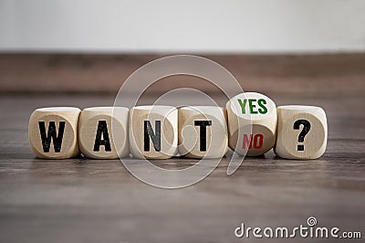 Cubes and dice on wooden background showing the word want with the choice yes or no Stock Photo