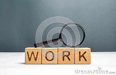Cubes labeled work and magnifying glass on top. Human resources, hiring specialists and specialized workers. Search for a new Stock Photo