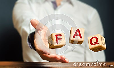 Cubes thrown by a man make word abbreviation acronym FAQ frequently asked questions. Convenient form of answers explanations for Stock Photo