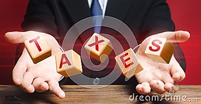 Cubes thrown by official or businessman make up word Taxes. Income declaration, tax payment, State and Local taxation. Management Stock Photo