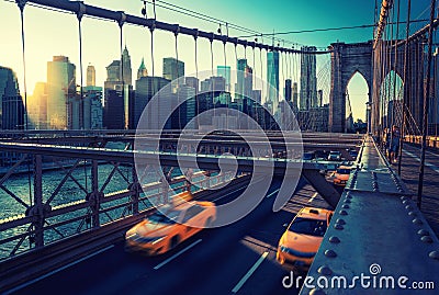 Cubs speeding at sunset on Brooklyn Bridge, Manhattan. One of the most iconic bridges in the world, New York City Stock Photo
