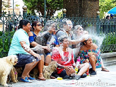 Group of people have fun whith spray Editorial Stock Photo