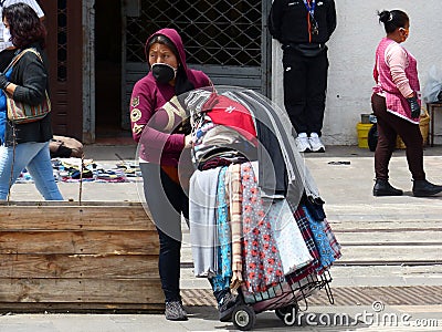 Woman street seller wearing mask, Ecuador Editorial Stock Photo