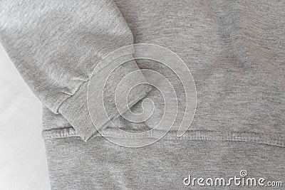 Cuff and part gray sweatshirt on white background. Warm casual unisex clothing. Close up Stock Photo