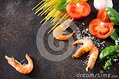 Culinary background for cooking with pasta, shrimps, tomatoes, fresh herbs and spices Stock Photo