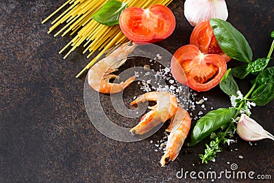 Culinary background for cooking with pasta, shrimps, tomatoes, fresh herbs and spices. Stock Photo